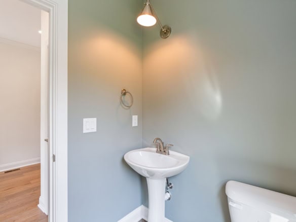 Interior bathroom with sink and wall-mounted light.