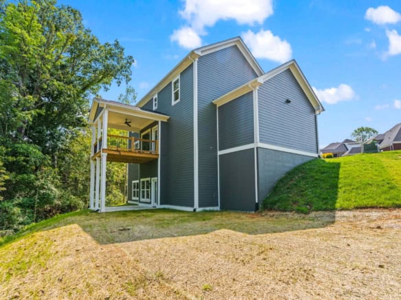 New construction home with blue siding and a deck at 6715 Hypoint Ridge Rd.