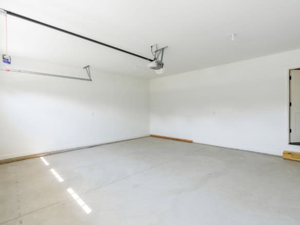 Garage interior with clean white walls and concrete floor at 6715 Hypoint Ridge Rd.
