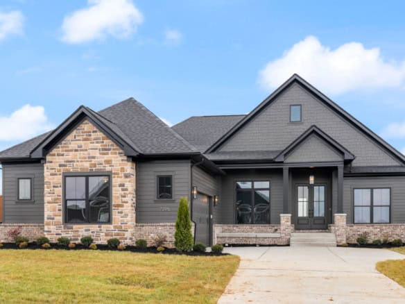 New construction home at 7395 Edith Way featuring modern design and stone details.