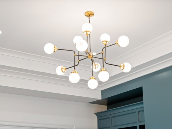 Elegant modern chandelier with multiple globe lights in a contemporary home.