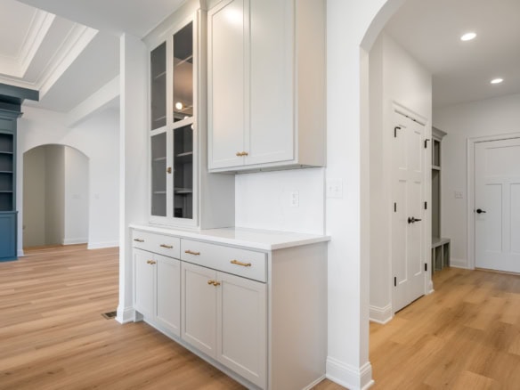 Bright, modern interior with white cabinetry and hardwood floors at 7395 Edith Way.