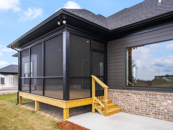 New black screened porch with wooden steps at 7395 Edith Way.