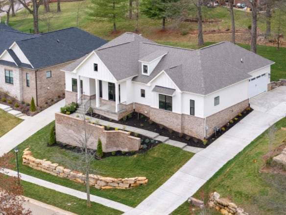 Beautiful new construction home with landscaped yard and driveway at 7517 Beechspring Farm Blvd.