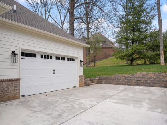 New concrete driveway and garage with white door at 7517 Beechspring Farm Blvd.