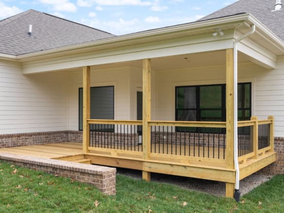 Custom wooden porch with railing at 7517 Beechspring Farm Blvd.