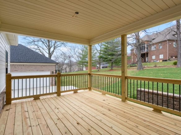 Beautiful outdoor wooden deck with railing at 7517 Beechspring Farm Blvd.