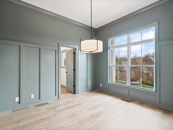 Interior of a new home with spacious living area, large window, and modern decor.