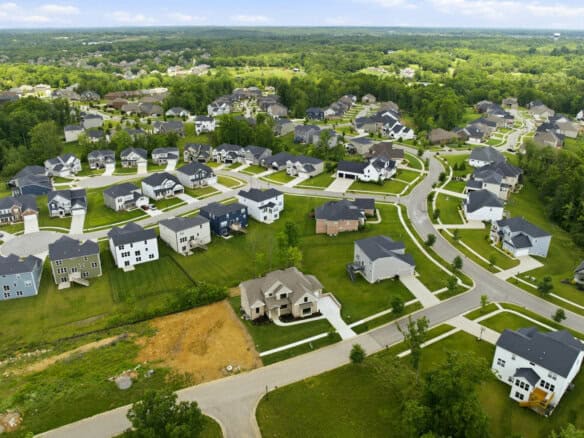 Aerial view of a new residential neighborhood with modern homes and green spaces.