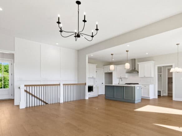 Spacious open-concept kitchen and living area with hardwood floors and modern lighting.