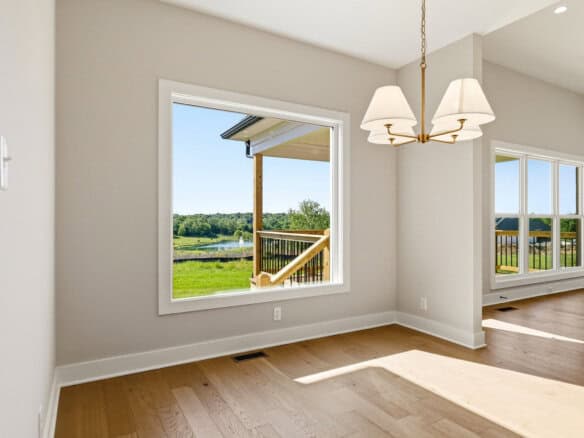 Bright interior with large windows overlooking a green landscape.
