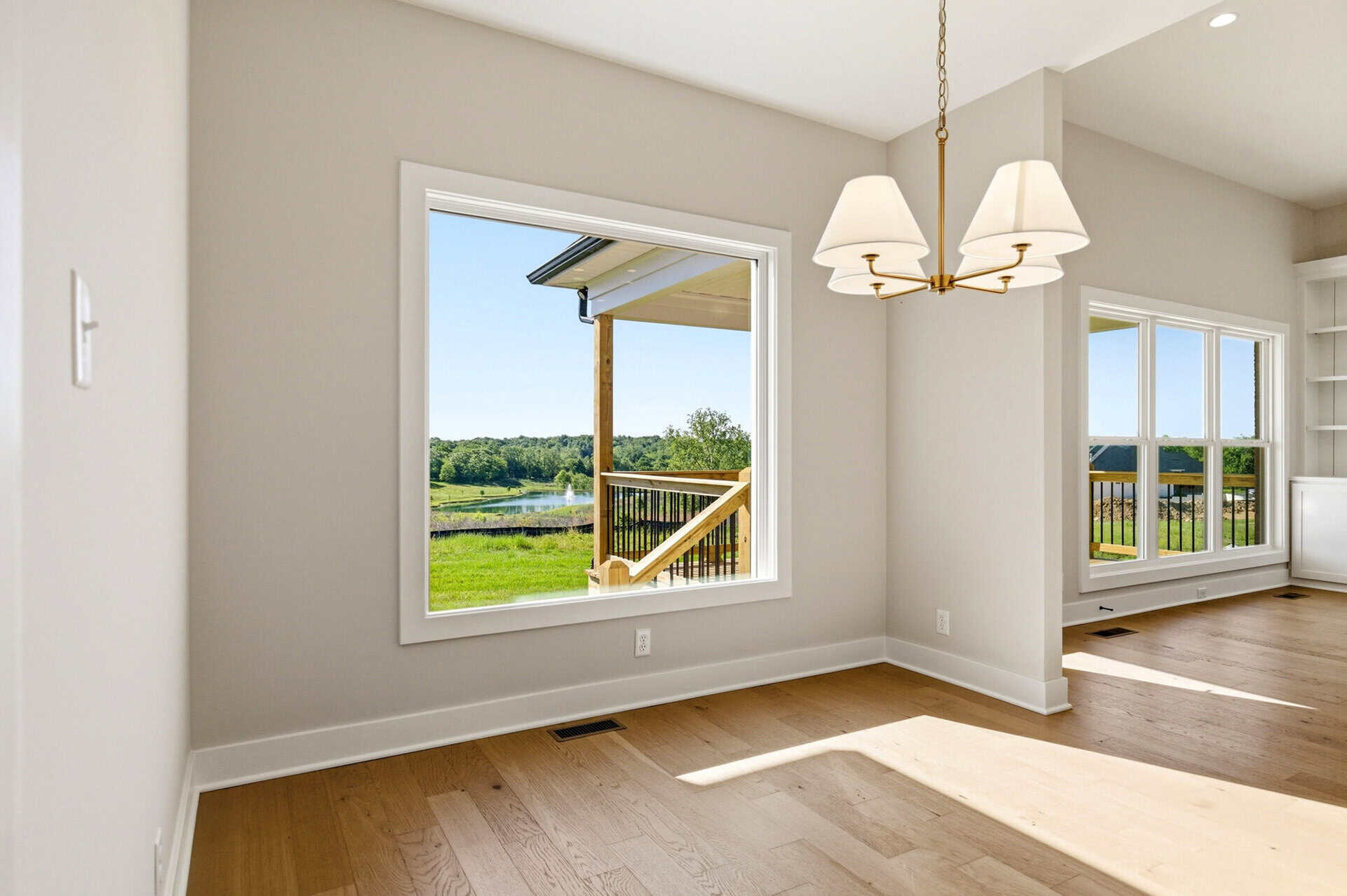 Bright interior with large windows overlooking a green landscape.