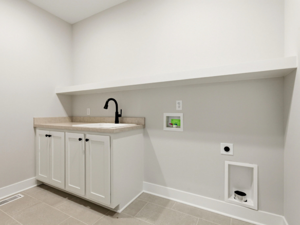 Modern white kitchen/utility alcove with beige countertop, black gooseneck faucet, and white cabinet base under a long shelf.