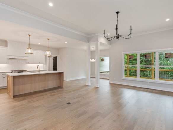 Spacious open-concept kitchen and living area with large window views.