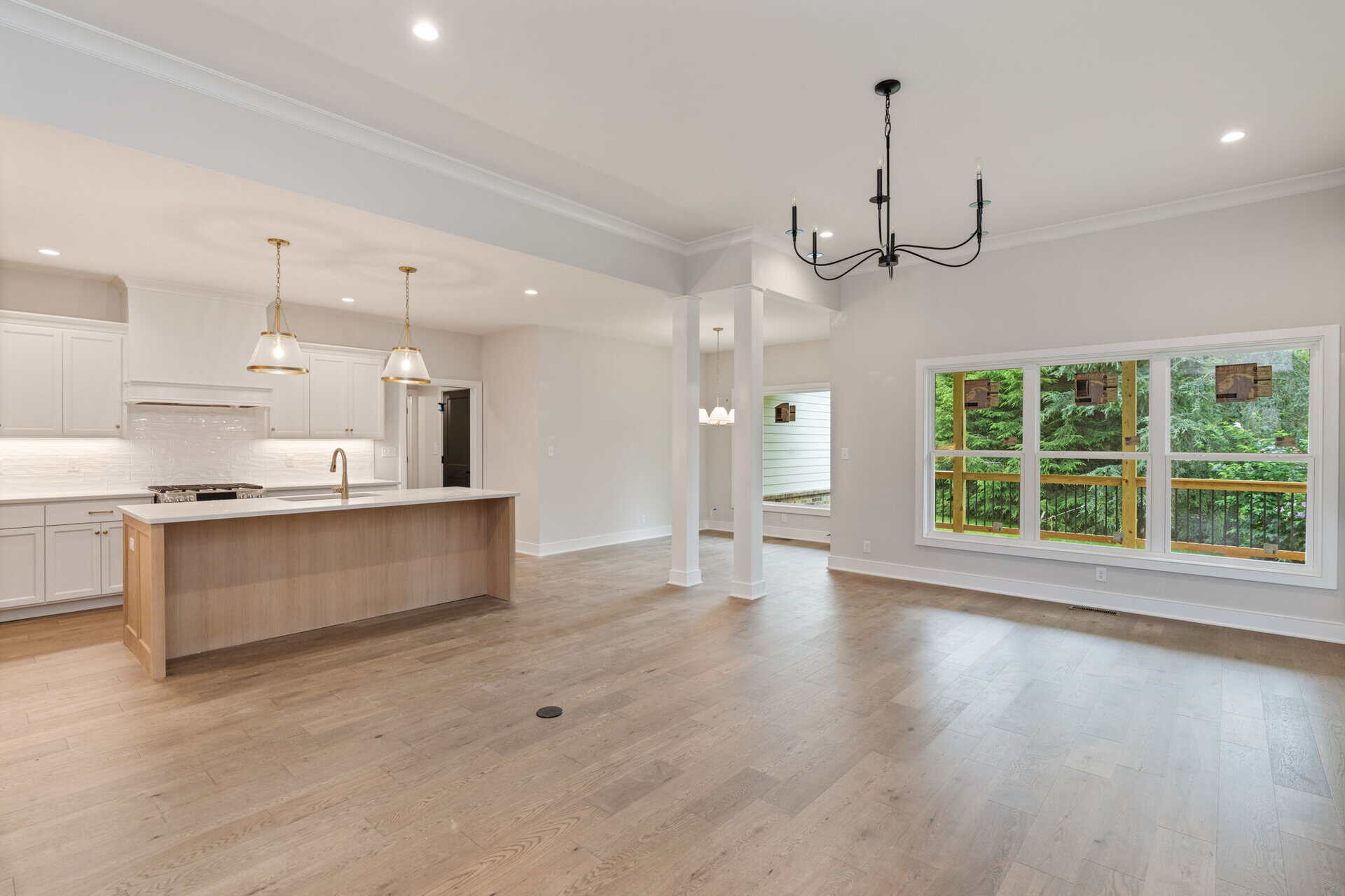 Spacious open-concept kitchen and living area with large window views.