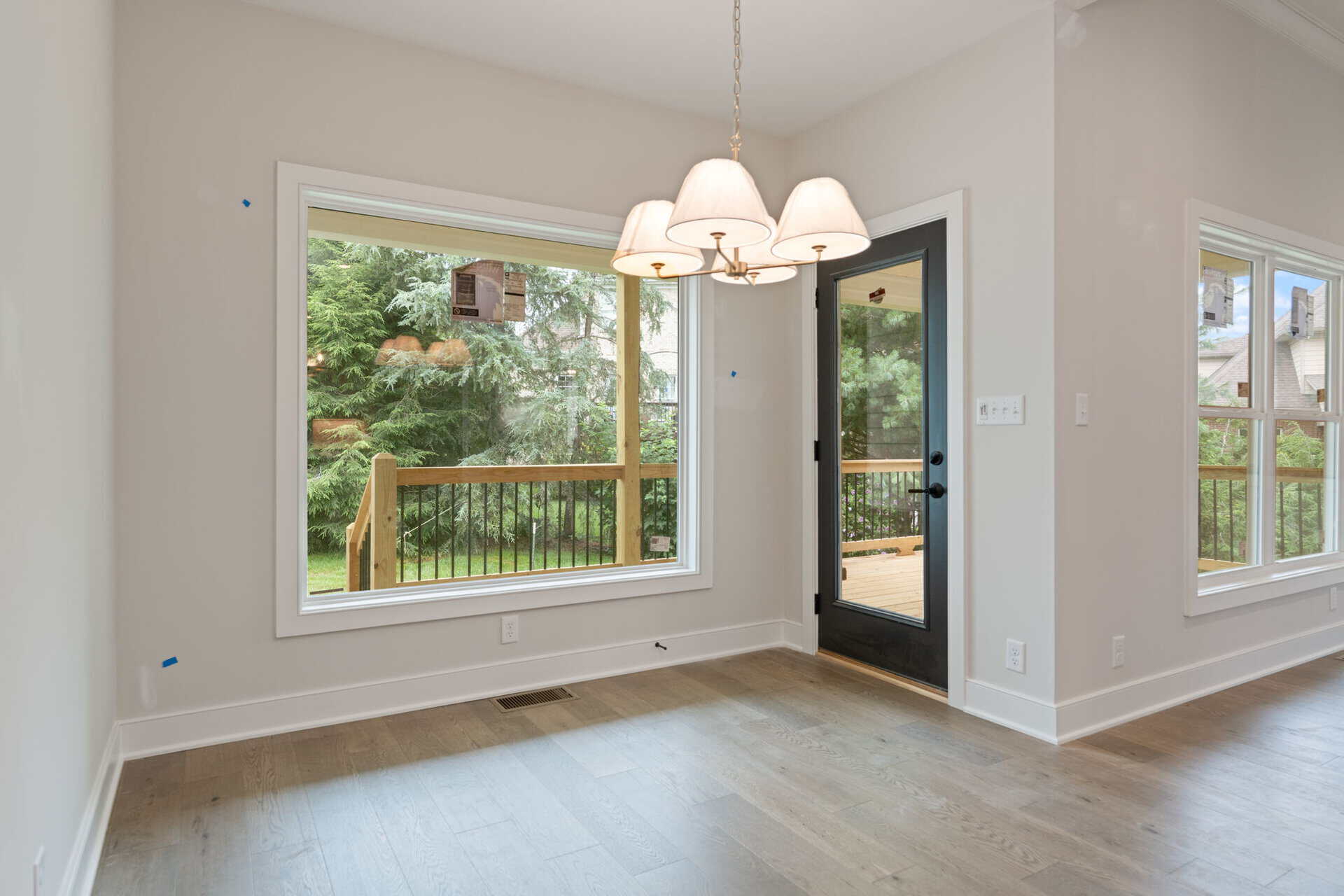 Bright dining area with large window and glass door leading to deck.