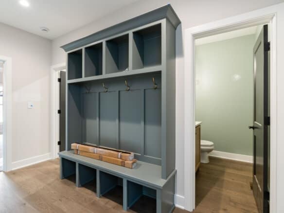 Custom mudroom with hooks and storage bench in a modern home.