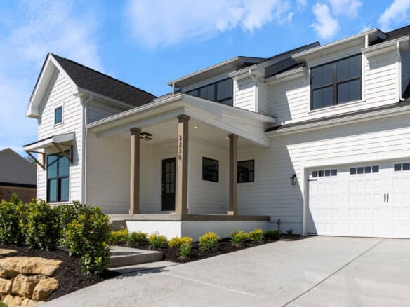 Modern white house with black window frames and a two-car garage.