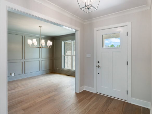 Bright entryway with white door and natural light in a modern home.
