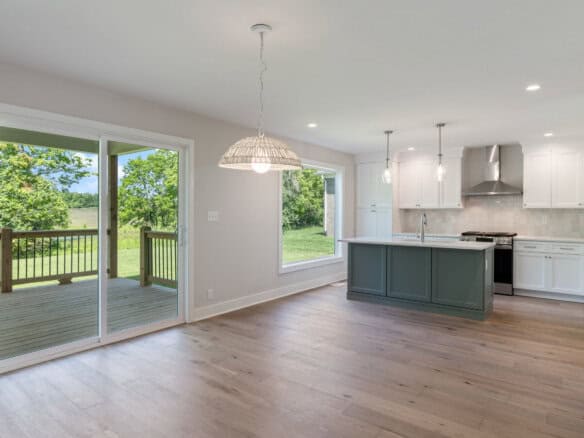 Open-concept kitchen and dining area with sliding glass doors to backyard.