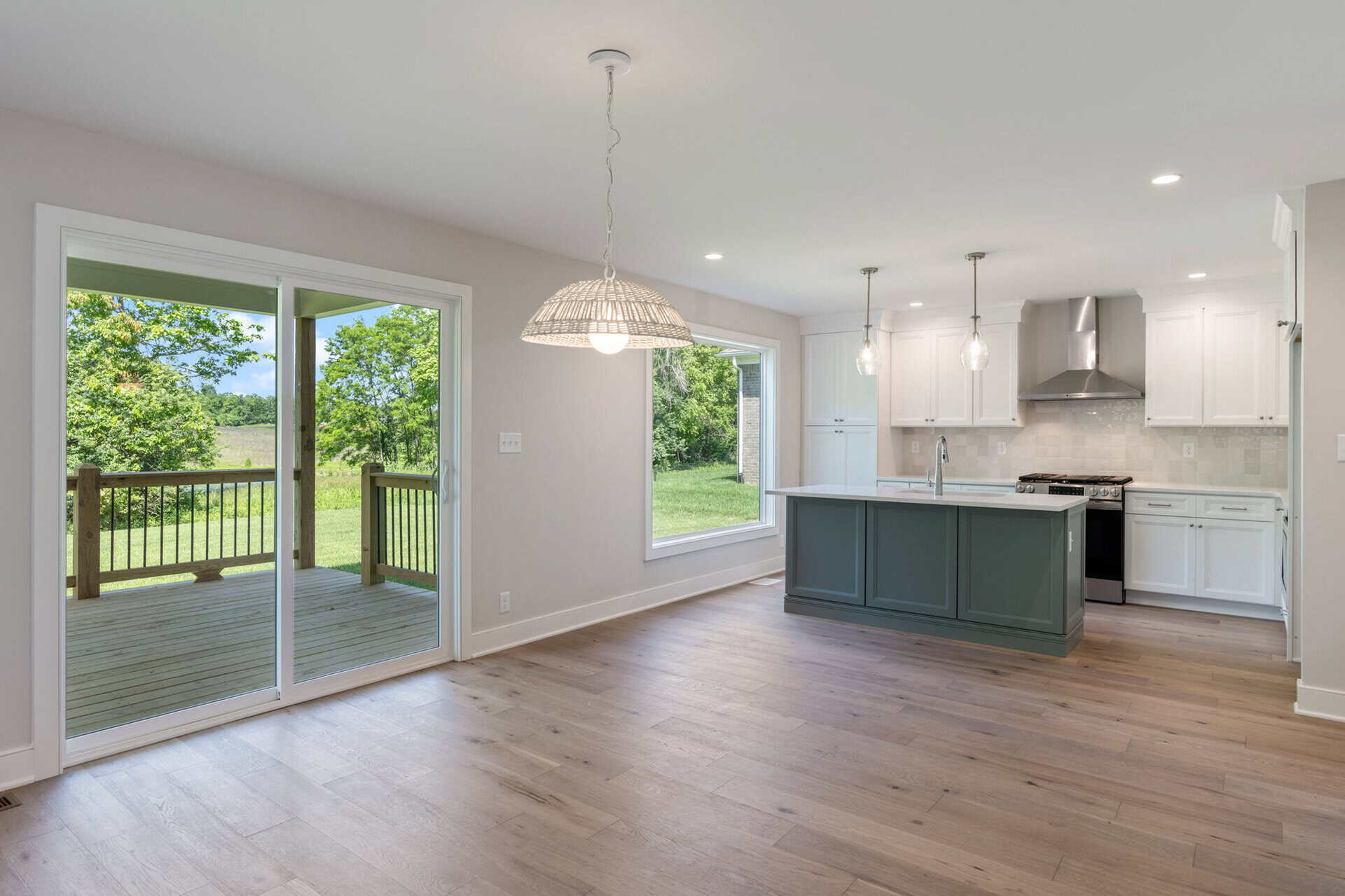 Open-concept kitchen and dining area with sliding glass doors to backyard.