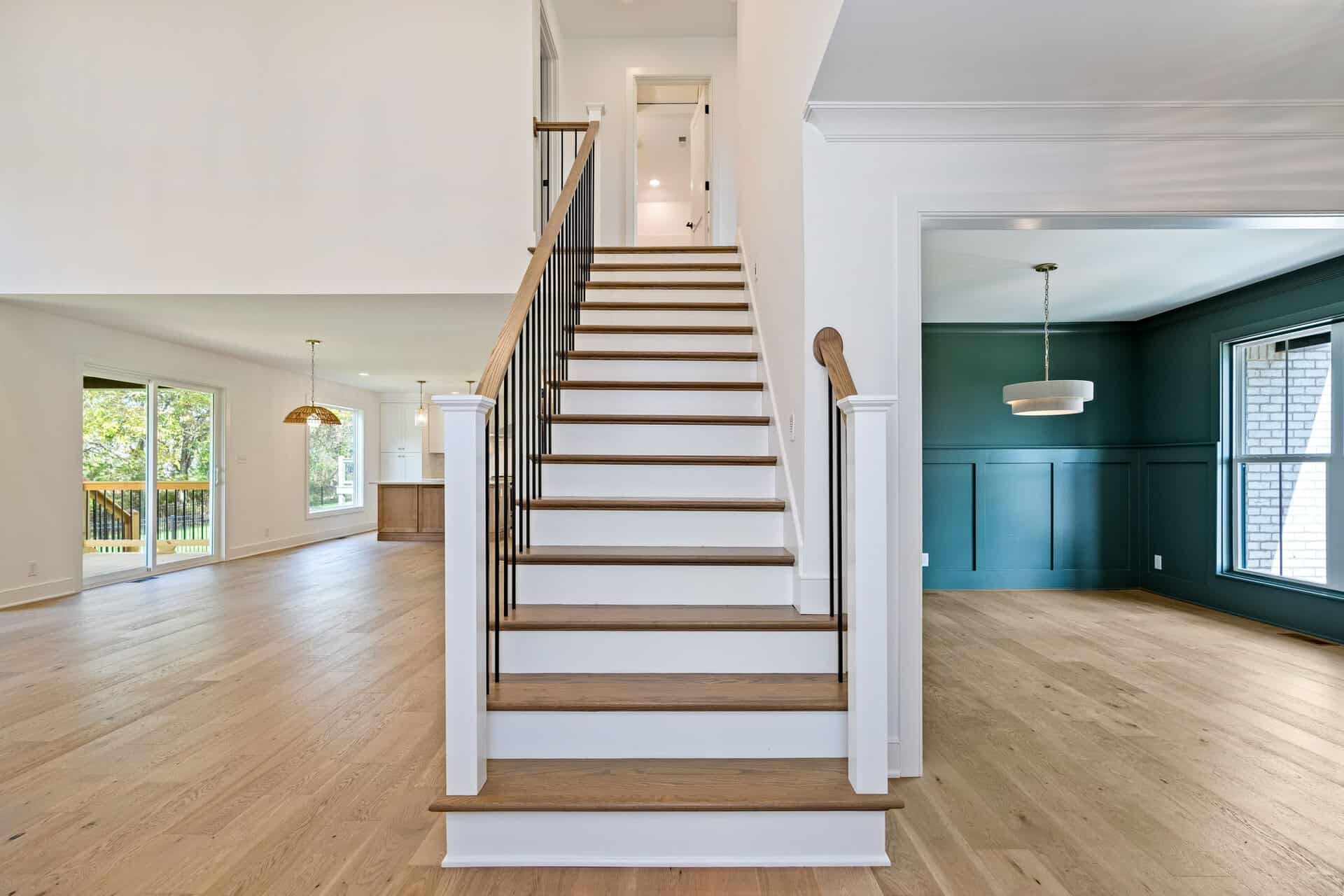 Spacious interior with staircase and large windows in a modern home.