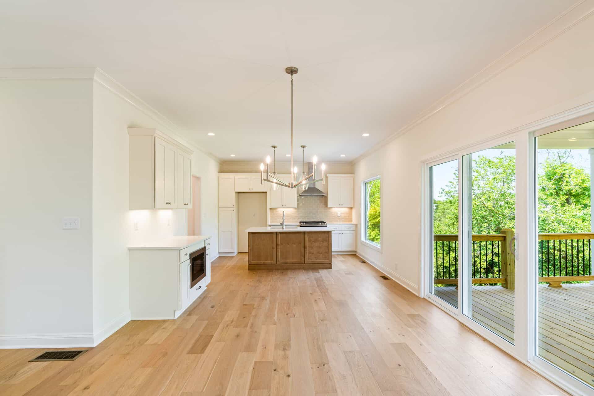 Spacious open-concept kitchen and dining area with large windows and sliding door.