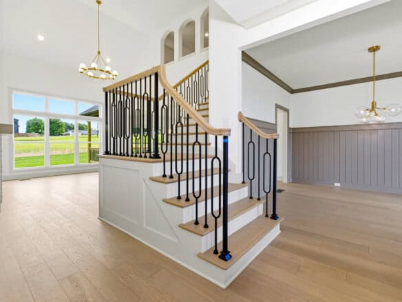 Bright interior with staircase and large windows in a luxury home.