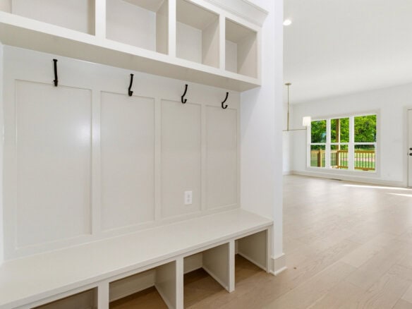 Bright, spacious living area with large windows and light wood flooring.