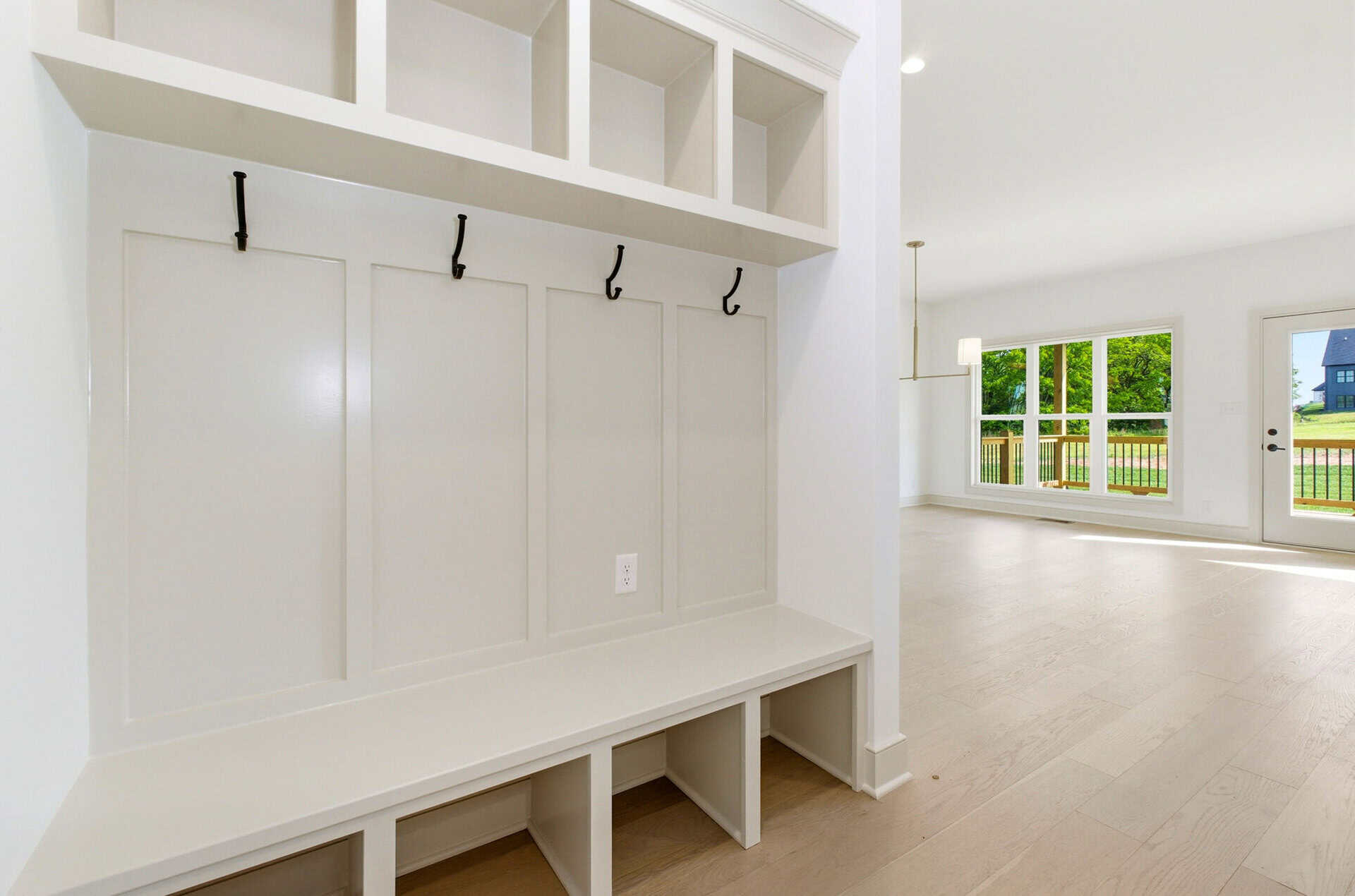 Bright, spacious living area with large windows and light wood flooring.