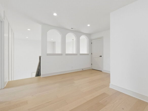 Bright, modern interior with white walls and light wood flooring.