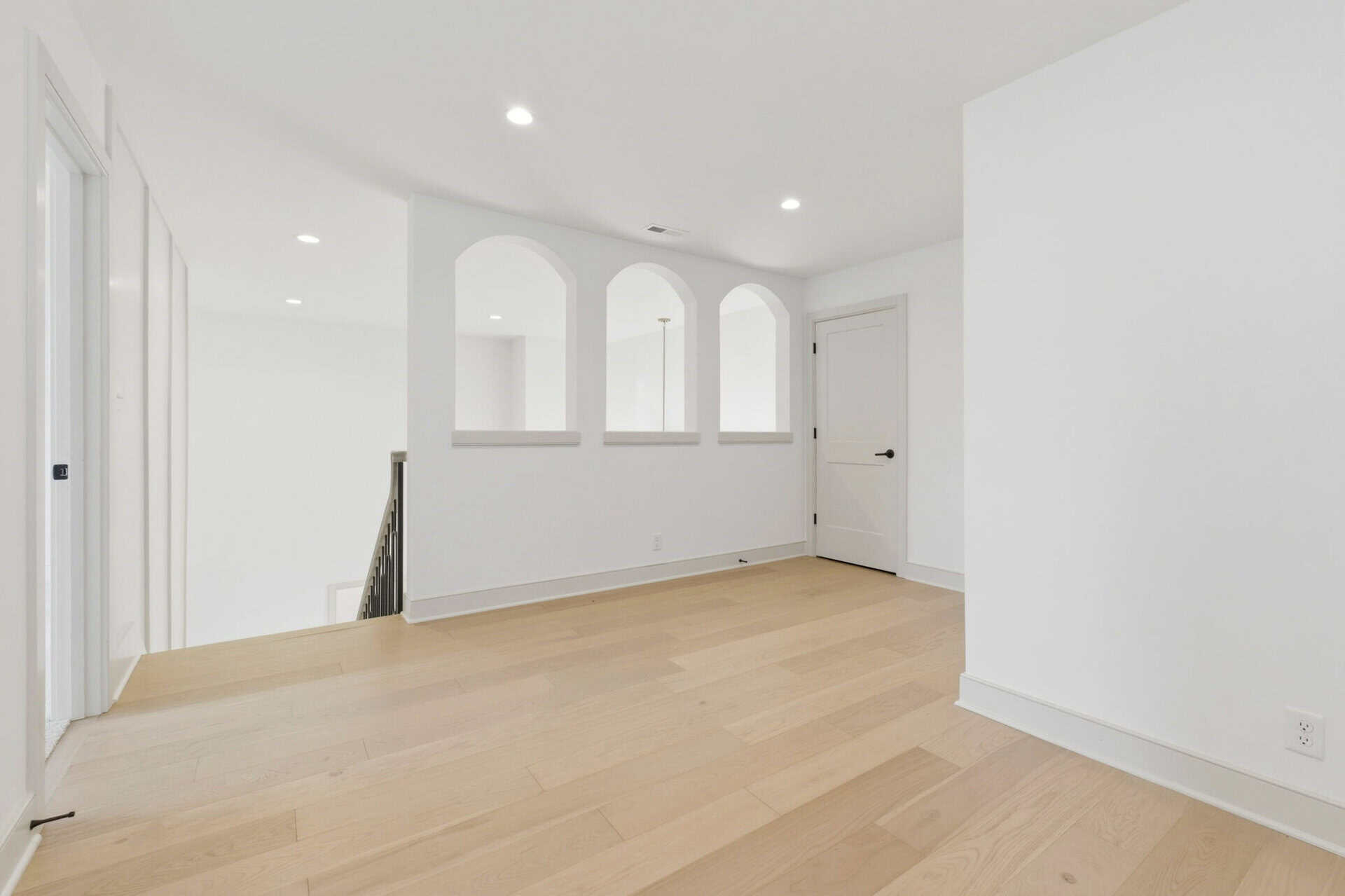 Bright, modern interior with white walls and light wood flooring.