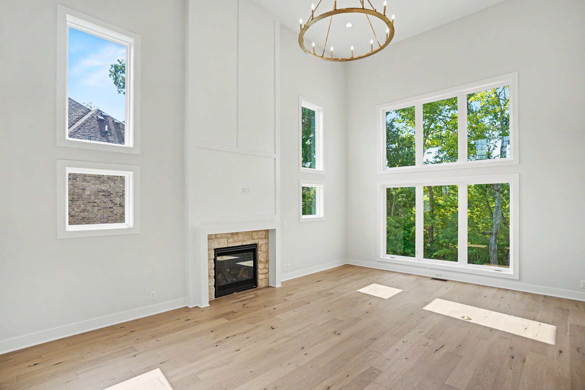 Bright living room with large windows and a modern fireplace.