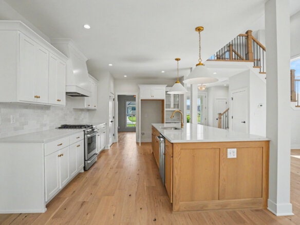 Modern white kitchen with island and high ceilings in Louisville home.