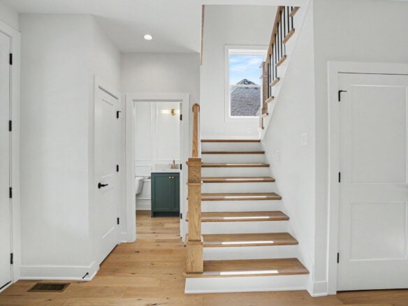 Bright entryway with staircase and natural light in a modern home.