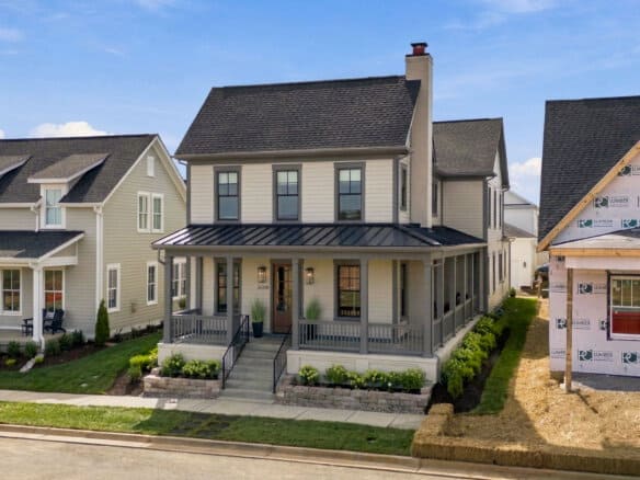 Newly built modern farmhouse with front porch and landscaping in Louisville, KY.