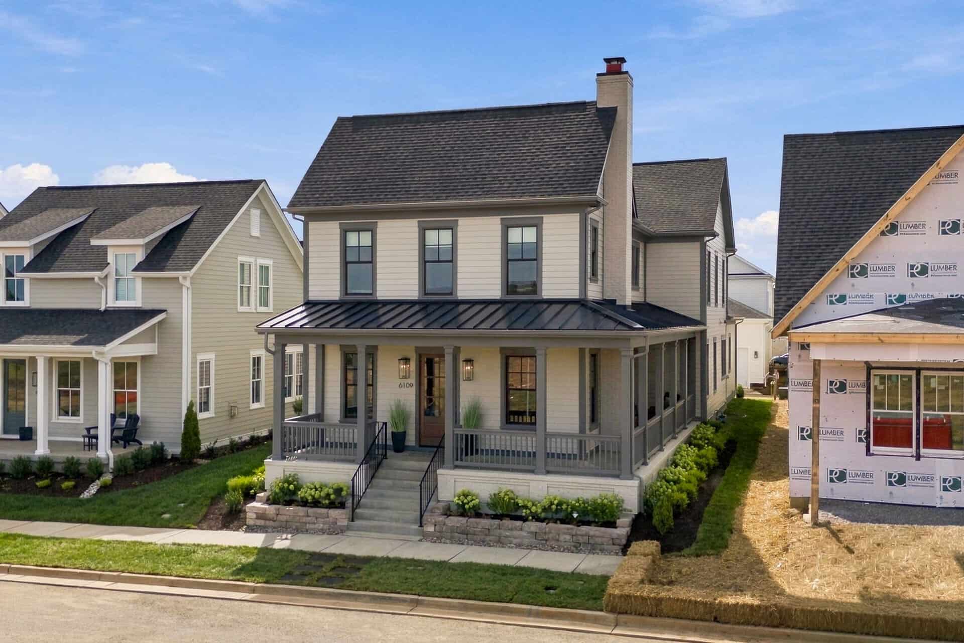 Newly built modern farmhouse with front porch and landscaping in Louisville, KY.