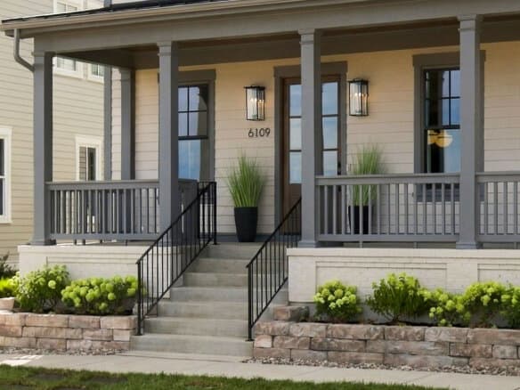 Front porch on a beige house with gray trim, columns, lantern lights, and the number 6109 by the door