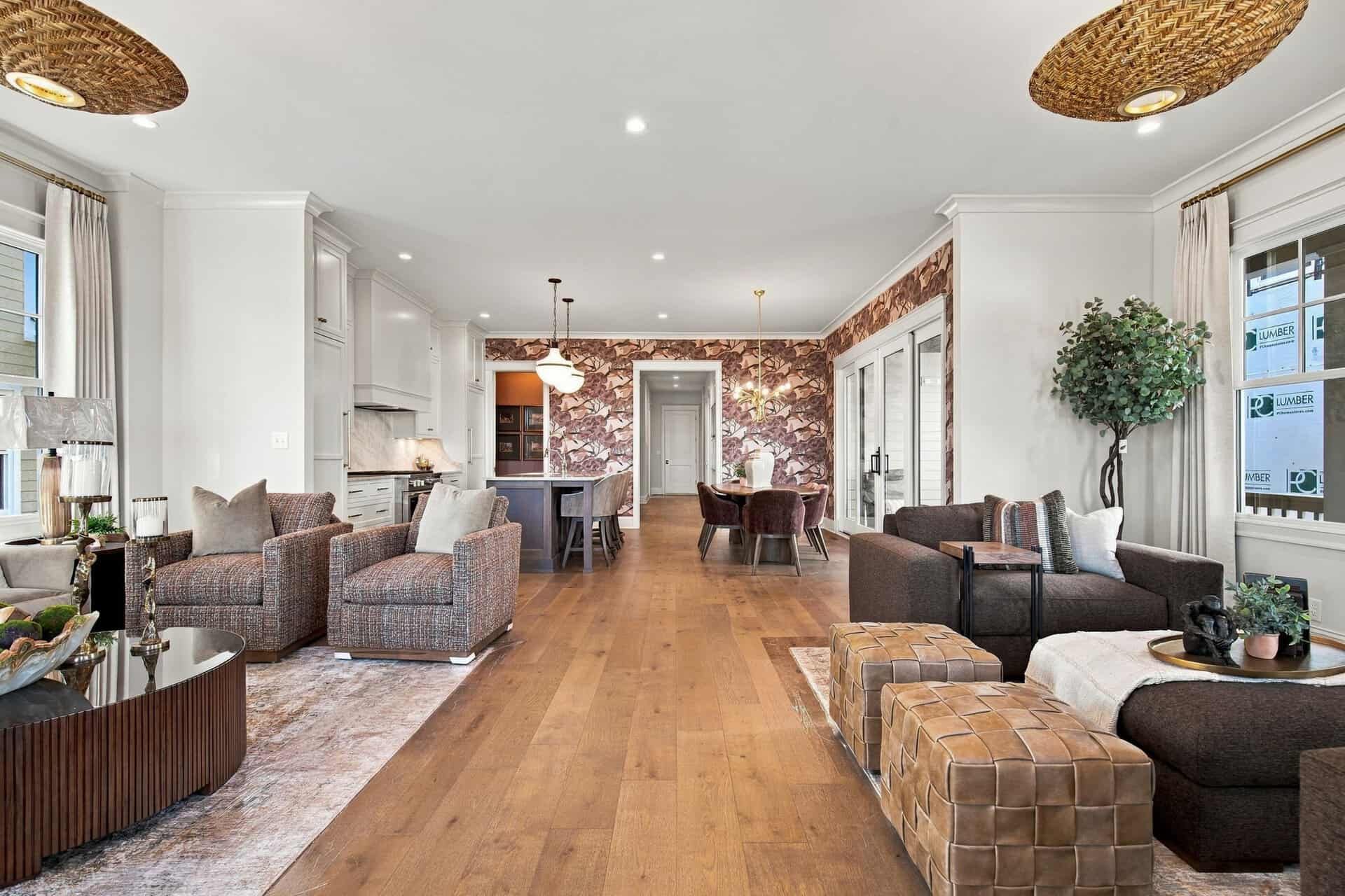 Spacious modern living room with hardwood floors, large windows, and stylish furniture.