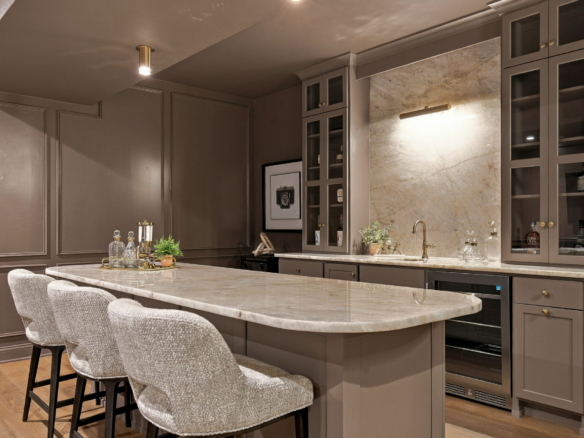 Contemporary grey kitchen with a marble island, bar seating, and glass-front cabinets.